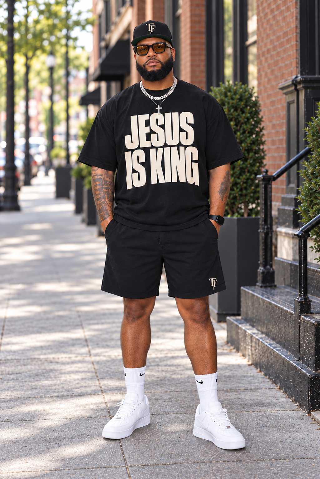 Model wearing the black Jesus Is King oversized tee