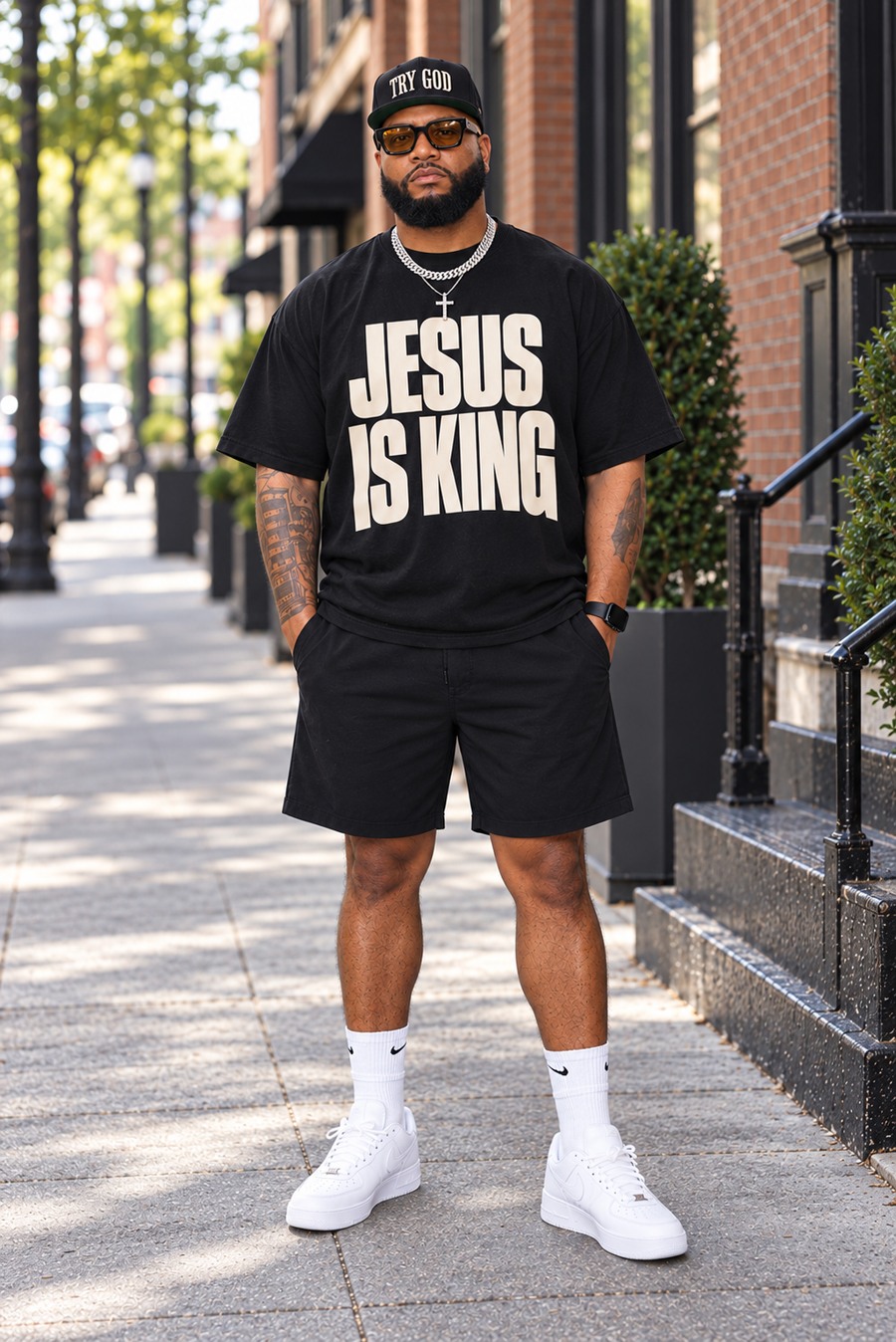 Model wearing the black Jesus Is King oversized tee